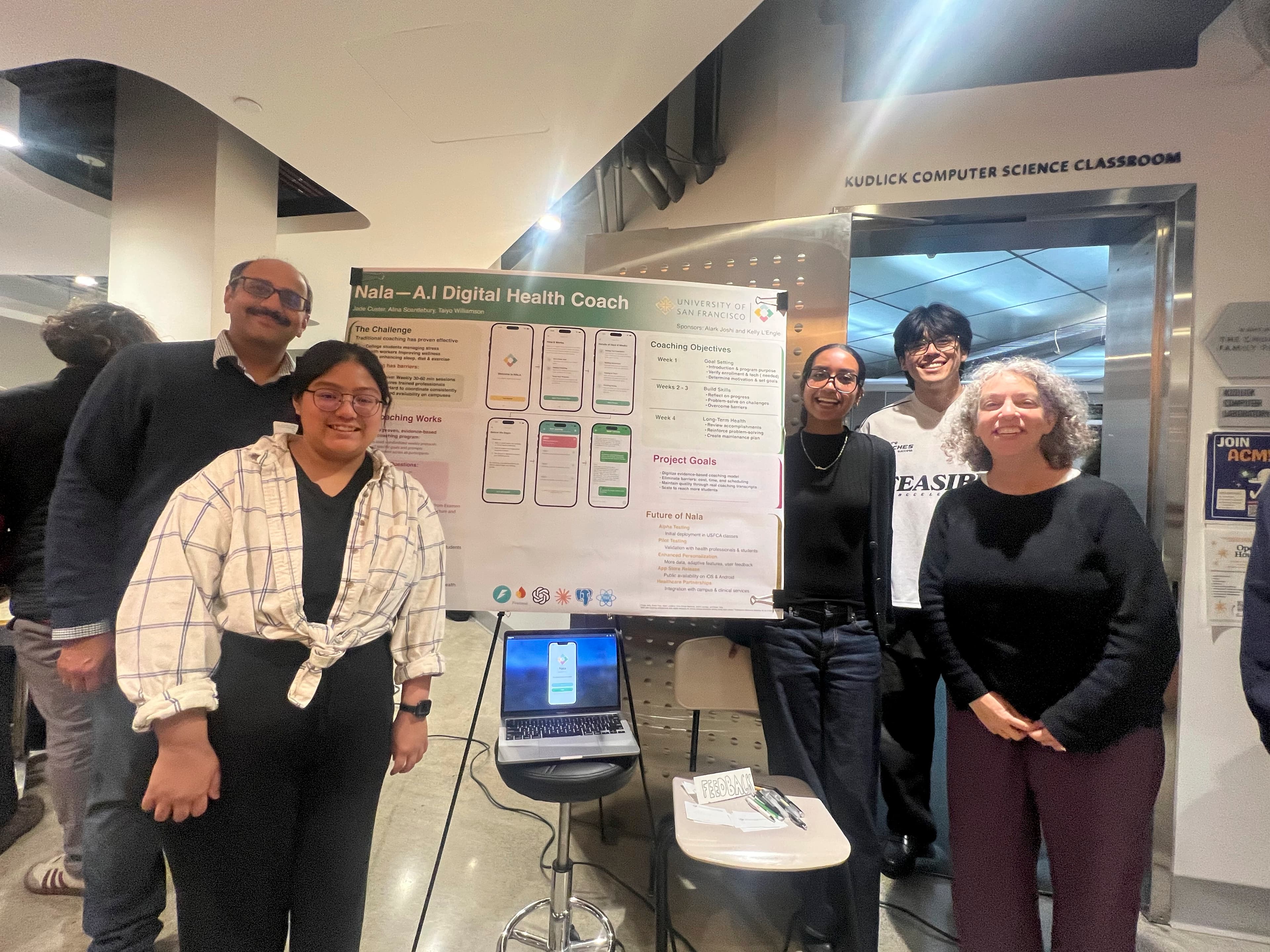 Photo with team and poster